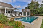 A large patio surrounds this heated pool